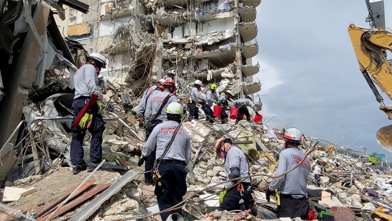 Rescue teams work on unstable hills of cement and steel in the hope of finding survivors.  Image via Reuters