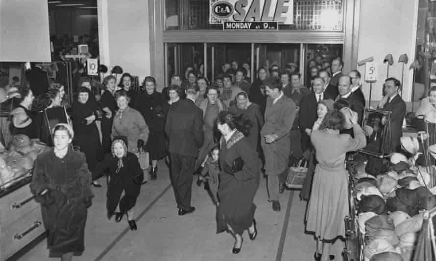 Shoppers flock through the entrance to a C&D clothing store.  A at Marble Arch at the beginning of the January 1956 sale