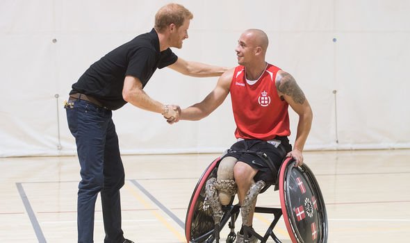 Prince Harry with an athlete at Invictus Games