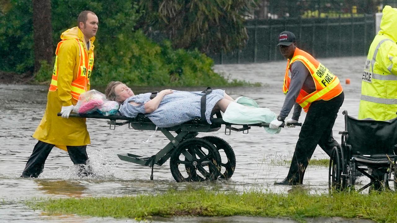 Rescue workers evacuate a nursing home resident.