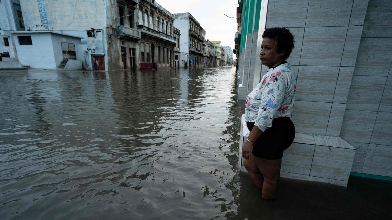 A woman inspects the flooded streets of the Cuban capital, Havana.